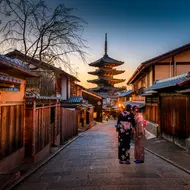 Two women in purple and pink standing on street in Gion, traditional district of Kyoto