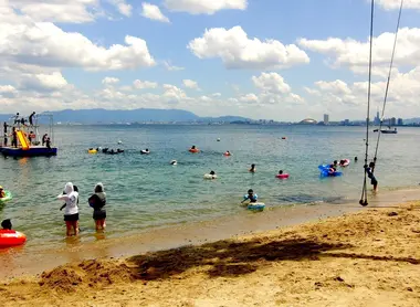 A beach on the island of Nokonoshima with the distant buildings of Fukuoka.