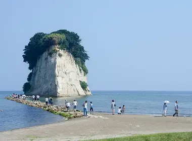 A small pebble path leads to the island of Mitsukejima