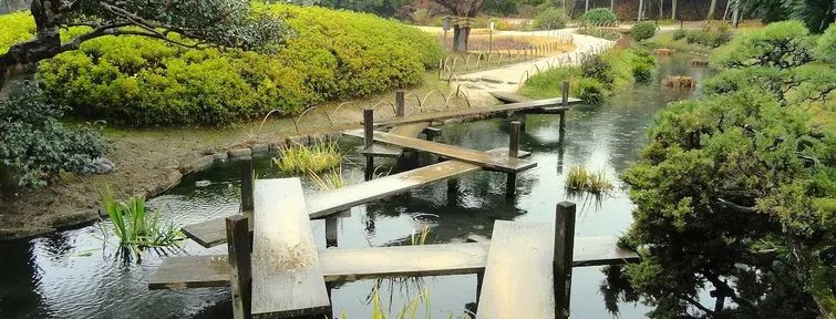 Wooden bridge across a pond in Okayama. 
